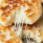 Delicious cheesy arepas served with melted cheese filling and golden crust