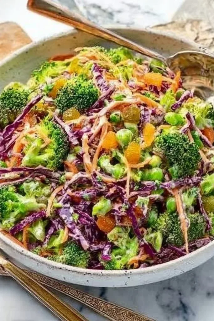 Bowl of fresh raw broccoli slaw with vibrant vegetables