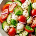 Juicy cucumber Caprese salad with tomatoes, mozzarella, and basil