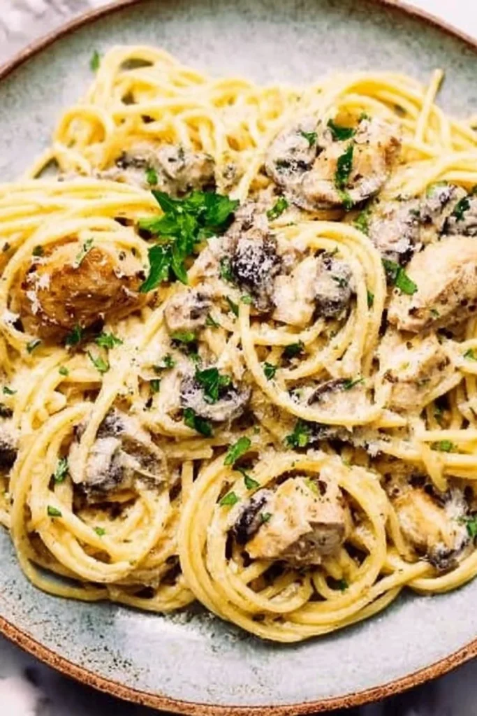 Delicious chicken tetrazzini served in a white bowl with toppings.