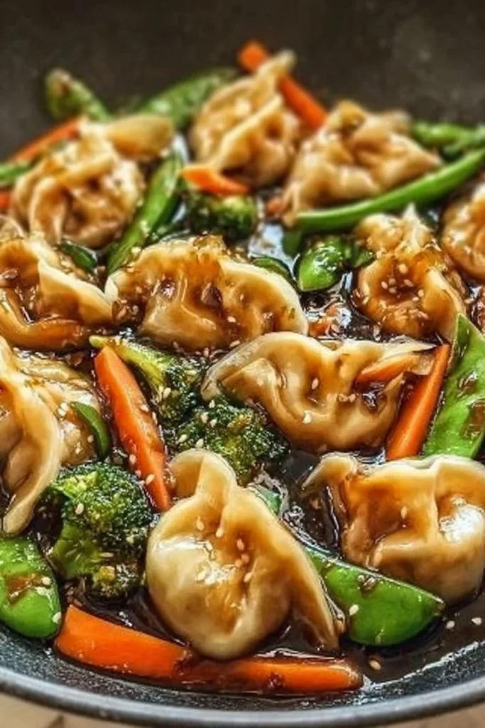 A vibrant bowl of potsticker stir fry with colorful vegetables and crispy dumplings