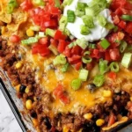 A tasty serving of Walking Taco Casserole topped with cheese and toppings