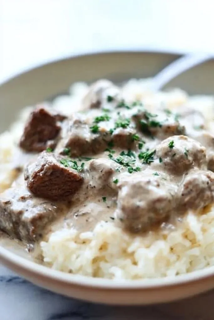 5-Ingredient Creamy Beef 2 Delicious plate of 5-Ingredient Creamy Beef served with fresh herbs.