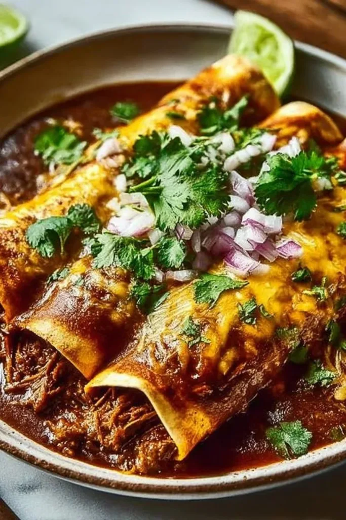 Delicious birria enchiladas topped with cheese and fresh herbs