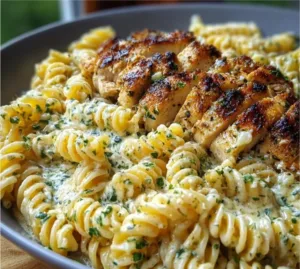 Cheesy creamy garlic parmesan chicken twisted pasta served in a bowl