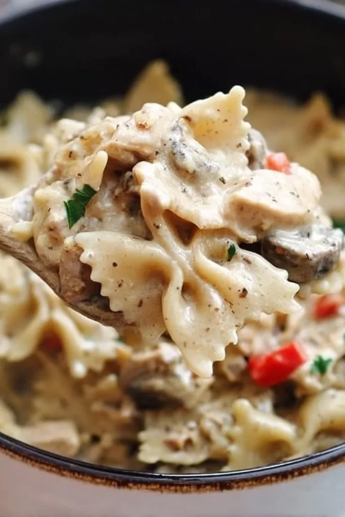 Creamy turkey bowtie pasta with fresh ingredients in a white bowl