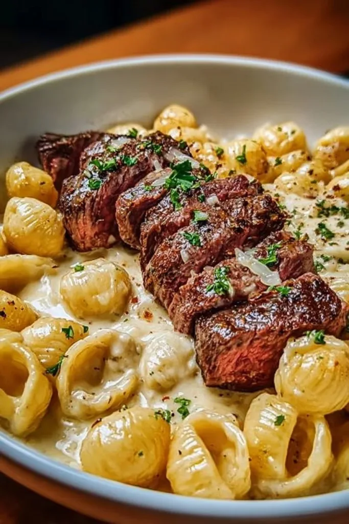 Garlic Butter Alfredo Steak Pasta with creamy sauce and tender steak pieces