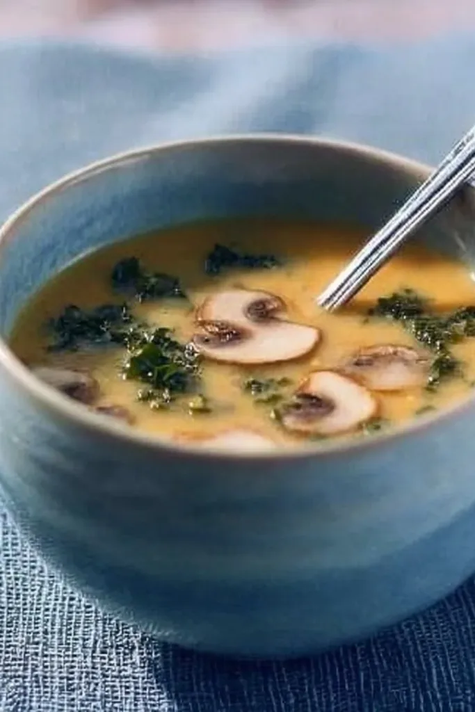Bowl of yellow split pea soup garnished with smoked paprika
