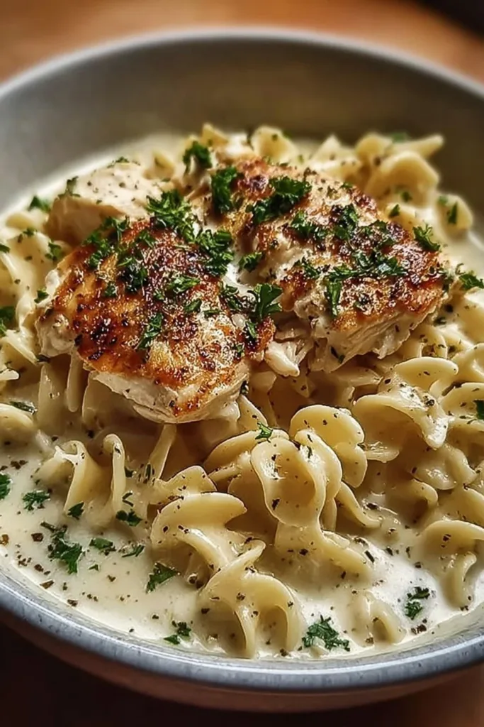 Delicious bowl of cozy chicken and noodles with herbs and spices