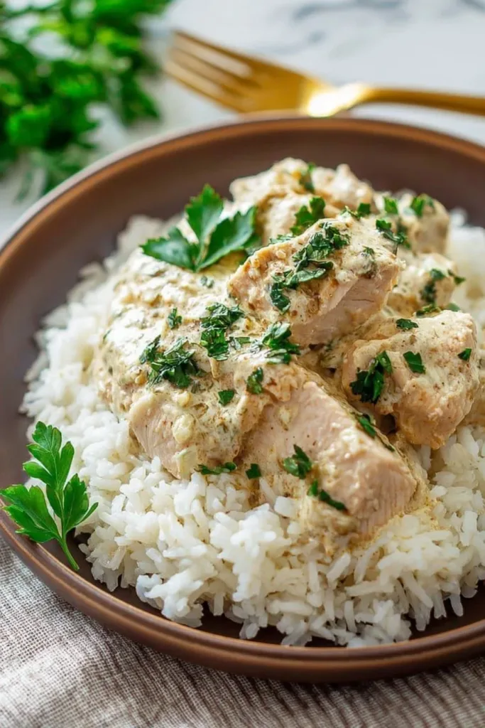 Delicious creamy crockpot chicken and rice dish served in a bowl