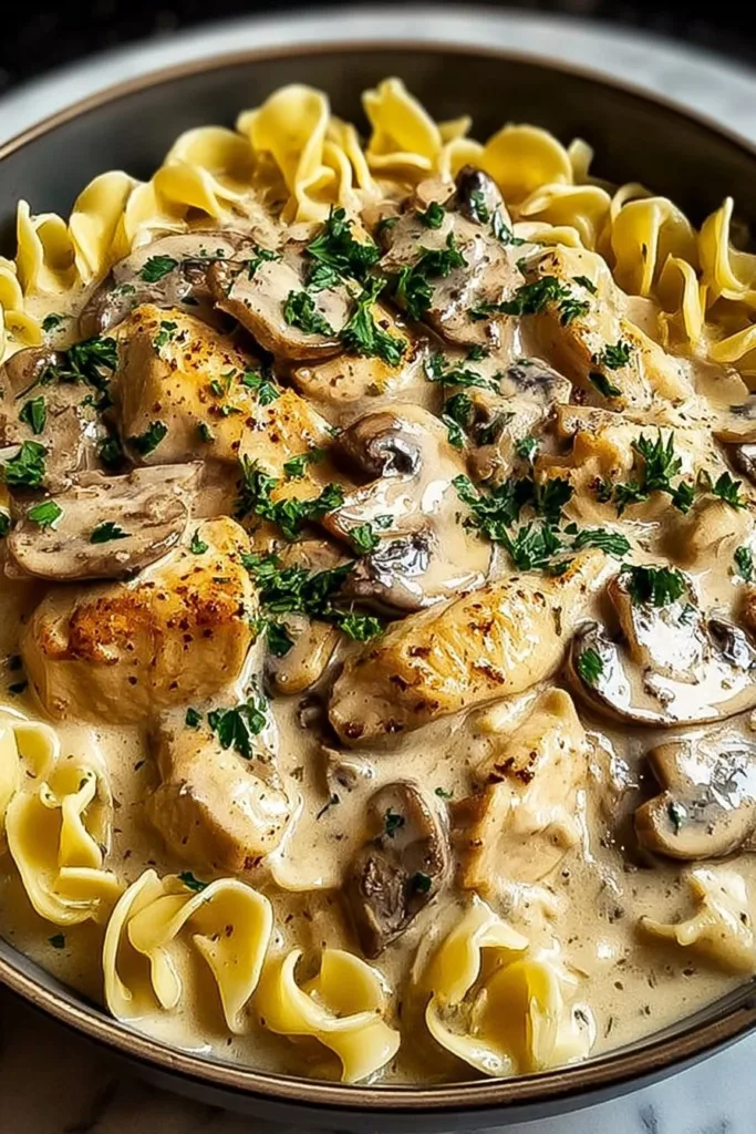 Creamy Chicken Stroganoff served with pasta on a plate