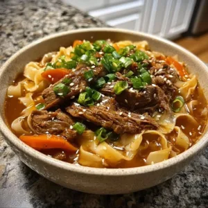 Bowl of comforting Korean beef noodles with flavorful broth and toppings