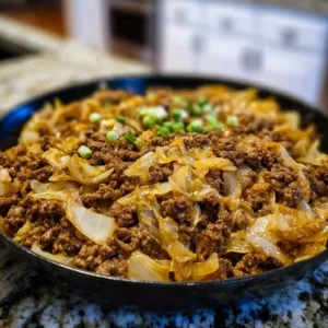 Low-carb ground beef and cabbage skillet dish served in a cast-iron pan