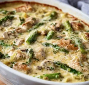 Creamy Chicken Bake with Asparagus 2 Creamy chicken bake with asparagus on a plate for a delicious meal