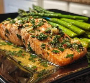 Garlic Butter Baked Salmon with Asparagus 2 Delicious garlic butter baked salmon with asparagus on a white plate