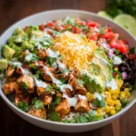 Colorful Chicken Burrito Bowl with fresh vegetables, rice, and toppings.