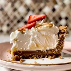 Delicious no-bake cheesecake topped with fresh berries and a graham cracker crust.