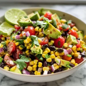 A colorful bowl of Cowboy Caviar salad with beans, corn, and peppers.