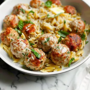 One pan garlic butter chicken meatballs served on a plate with herbs