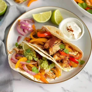Air Fryer Chicken Fajitas 1 Delicious Air Fryer Chicken Fajitas with colorful veggies in a serving dish