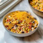 Delicious Frito Corn Salad served in a bowl, fresh ingredients and crunchy texture.