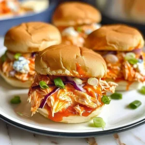 Slow Cooker Buffalo Chicken Sliders 3 Slow Cooker Buffalo Chicken Sliders served on a platter with sauces