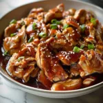 Slow cooker honey garlic chicken served with vegetables in a bowl
